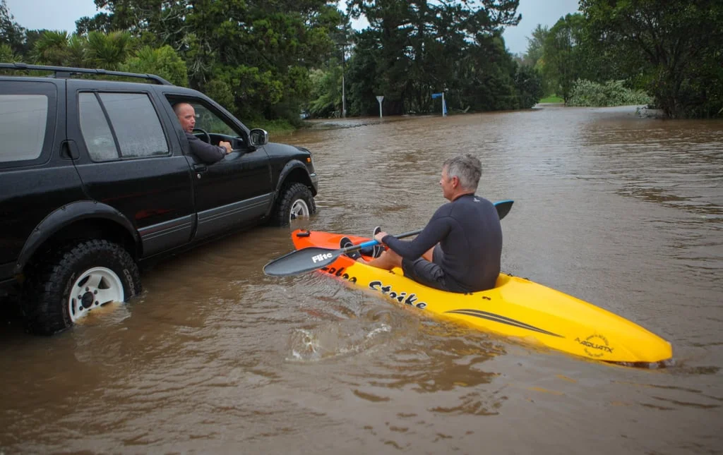 A man kayaks across a flooded street in Auckland, New Zealand, on February 14, 2023. Photo: Xinhua