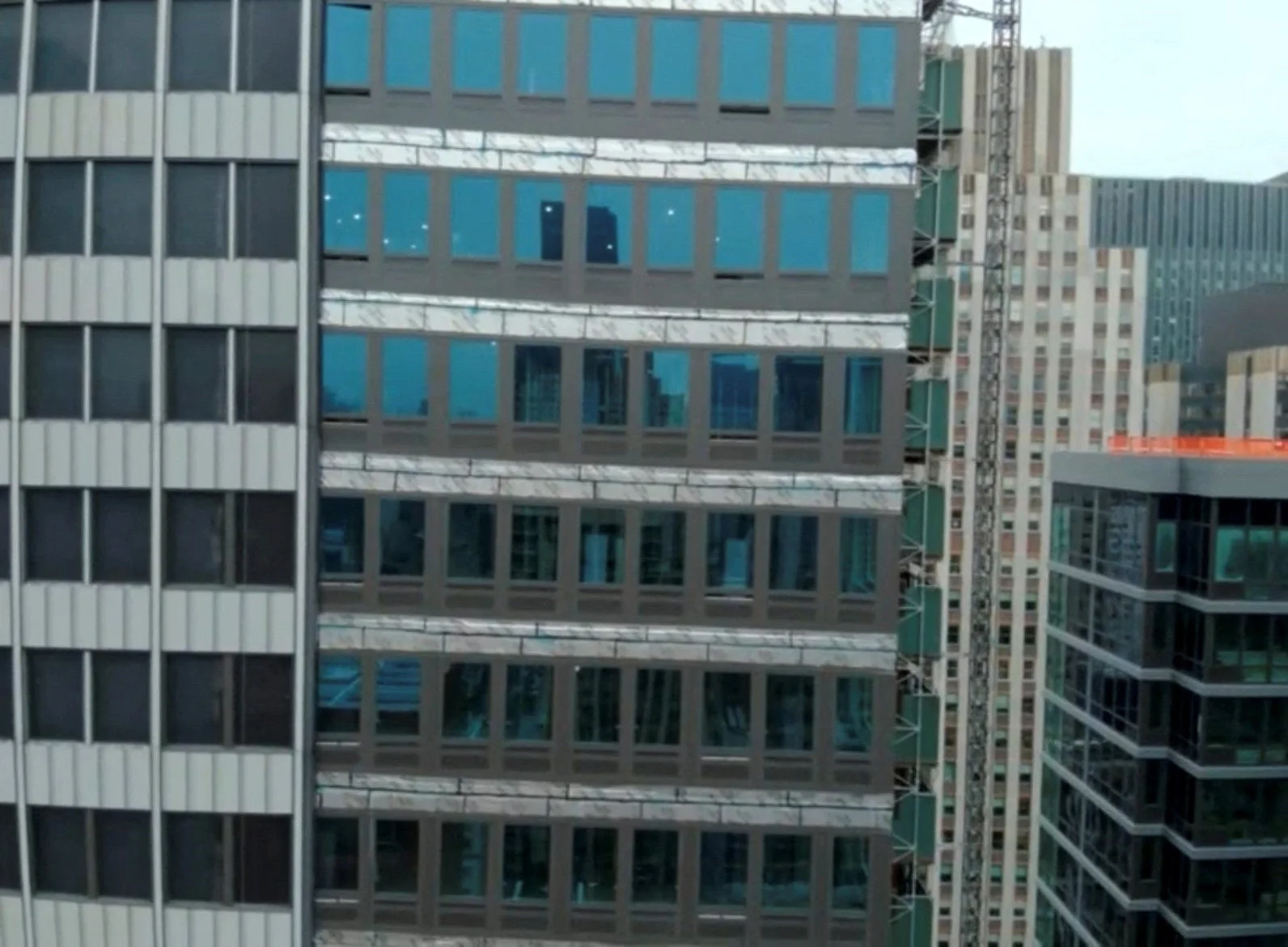 The buckling occurred on the 21st floor of the newer building; temporary supports are now in place as officials investigate