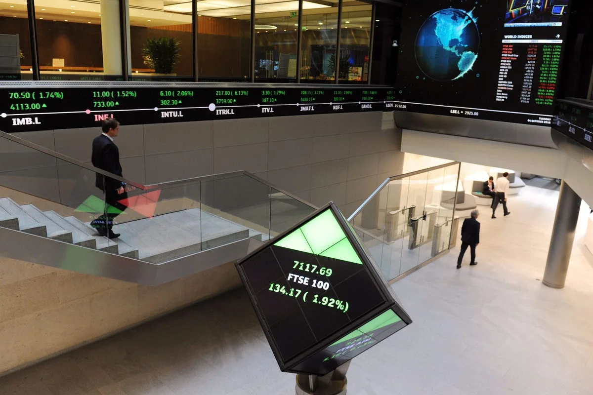 Vodafone gains help FTSE 100 close higher amid calmer trading