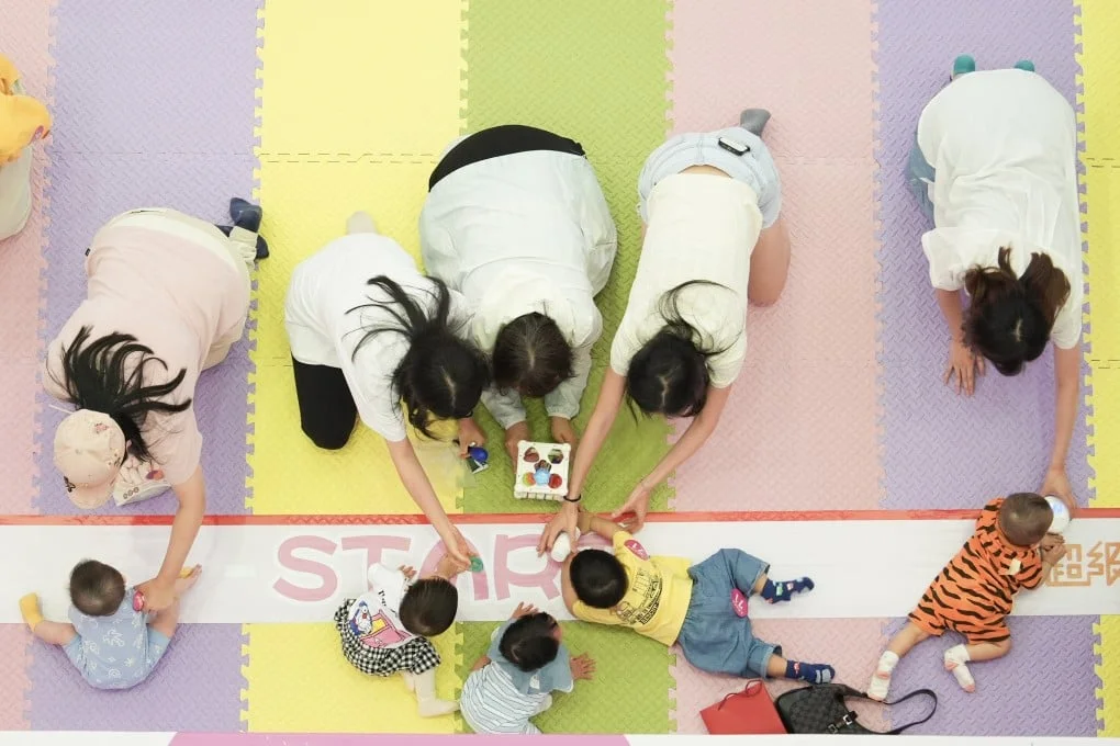 Babies and their parents take part in a Mother’s Day competition at a Tai Po shopping centre. Photo: Eugene Lee
