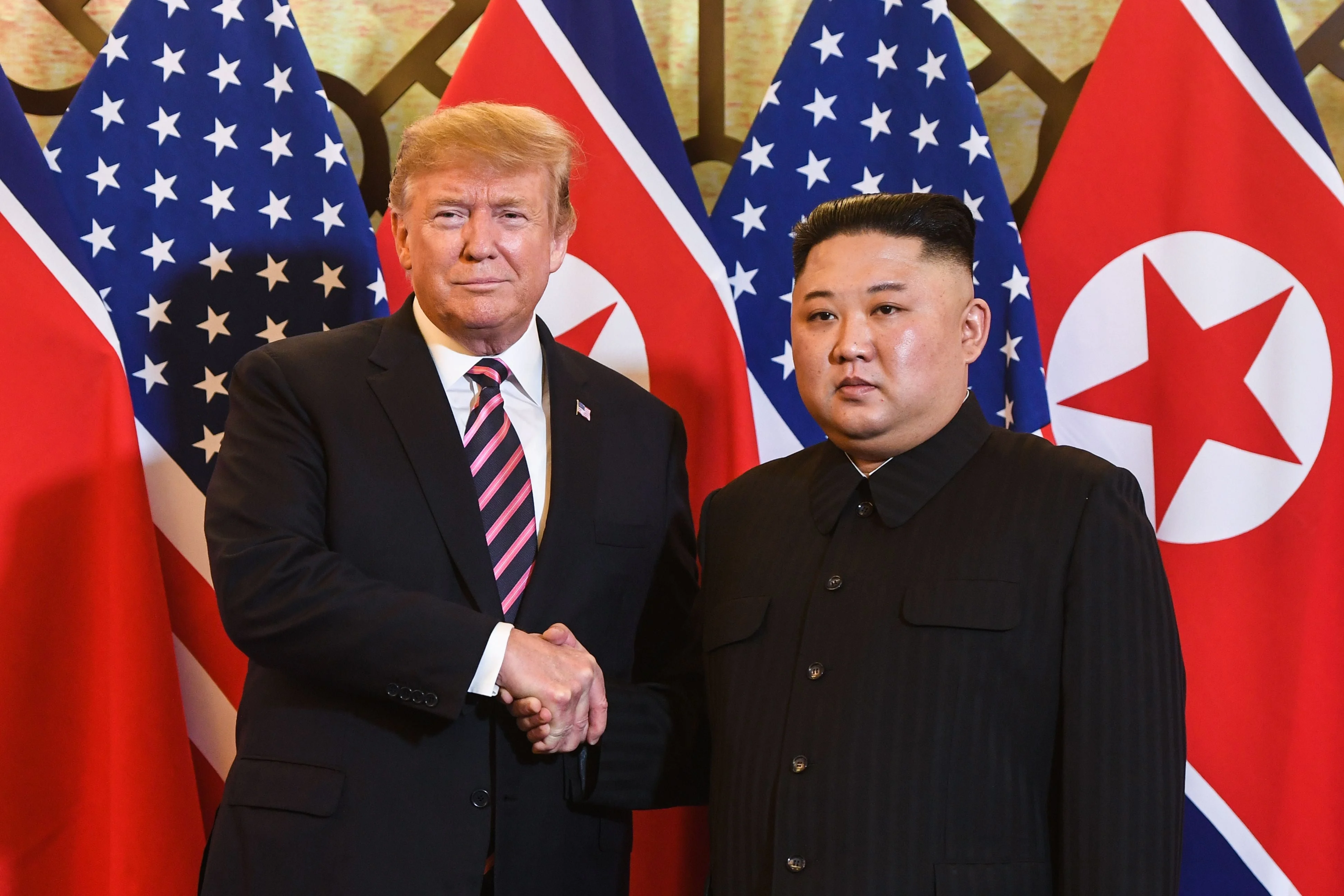 Trump shakes hands with Kim Jong Un before a meeting at the Sofitel Legend Metropole hotel in Hanoi on February 27, 2019
