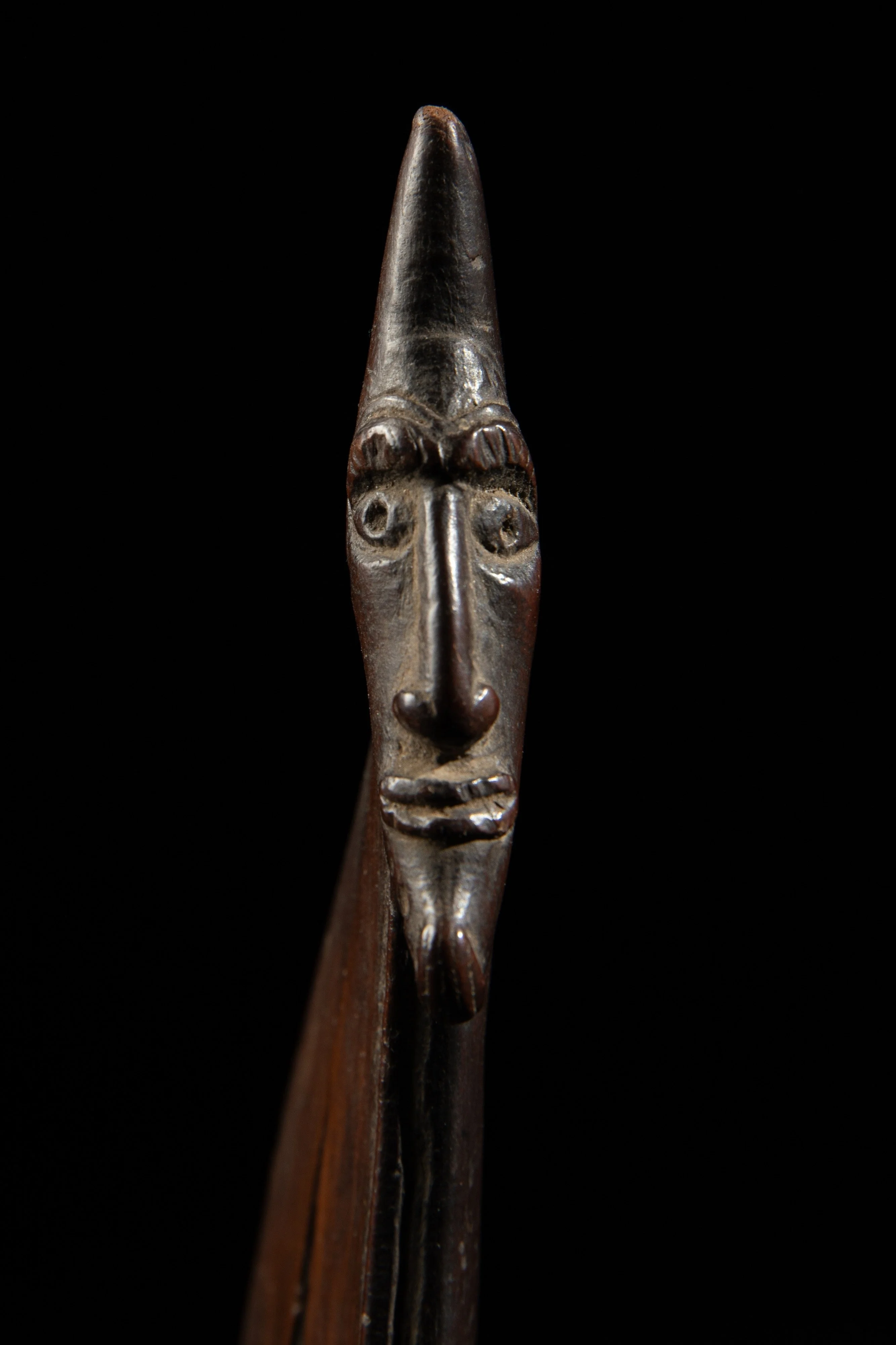 One of the heads on the wooden pendant