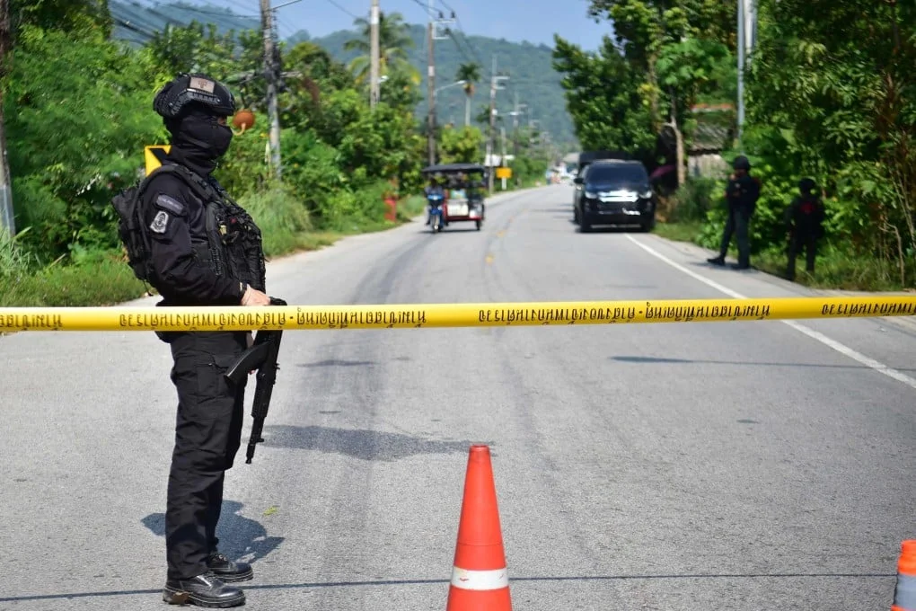 Thai soldiers stand guard at checkpoint in the southern province of Narathiwat on Sunday after the wave of attacks. Photo: AFP