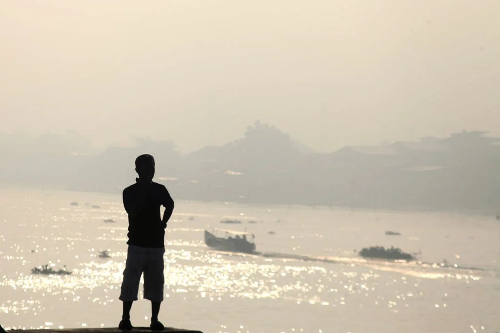 A man observes the haze from wildfires that blankets Musi River in Palembang, South Sumatra on Sunday. Photo: AP