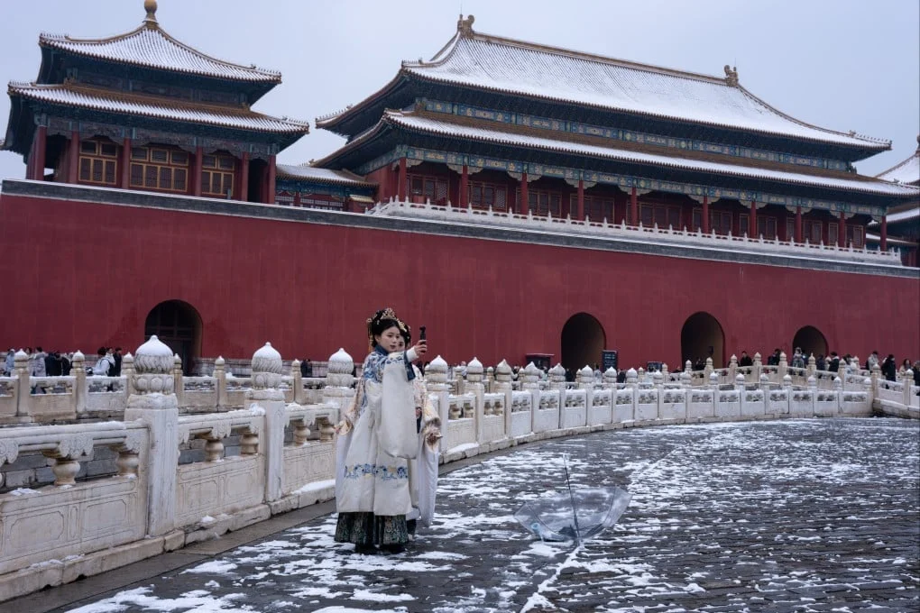 Women dressed in traditional costumes brave  sub-zero temperatures during a visit to Beijing’s Forbidden City on March 5. Photo: Robert Ng