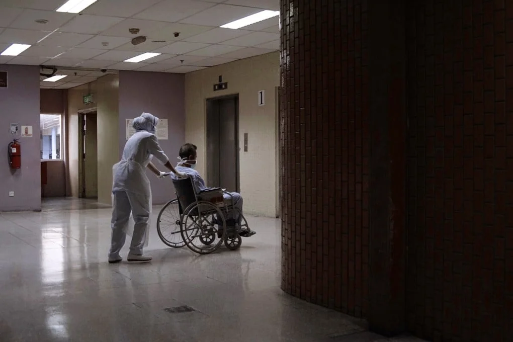 A nurse moves a patient in a wheelchair at Kuala Lumpur Hospital in Malaysia in April 2020. Photo: Getty Images