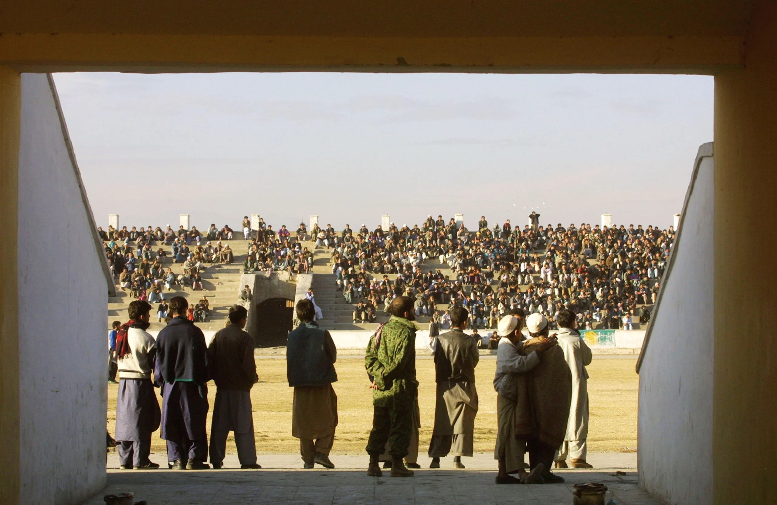 Figures stand at the entrance to the stadium
