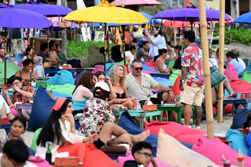 Tourists enjoy their holidays at Kuta beach near Denpasar on Indonesia’s resort island of Bali in April. Bali received roughly 16.3 million tourists last year, the majority Indonesians. Photo: AFP