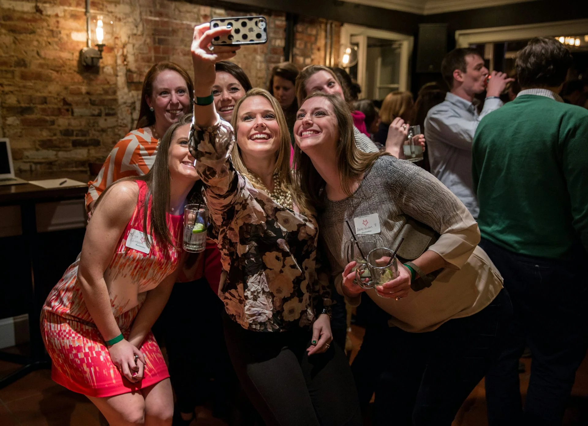 A group of young women gather for a selfie.